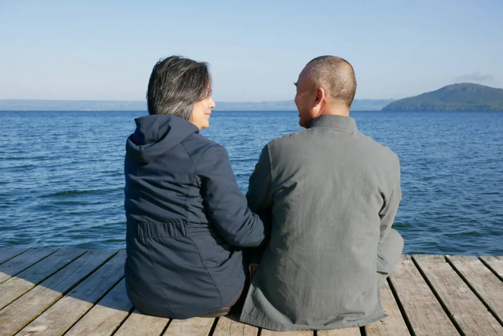 Yuan Tze und seine Frau Melissa von hinten sitzend an einem Steg fotografiert.